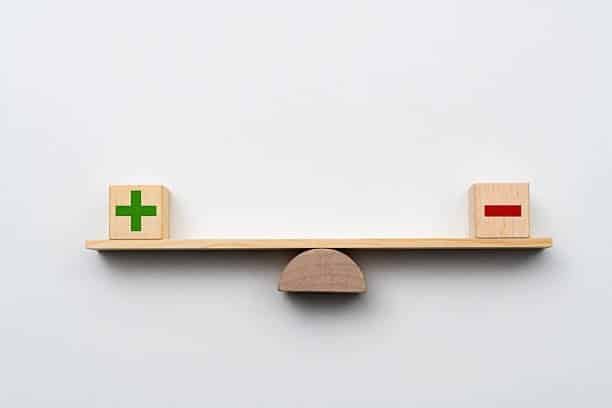 Seesaw with plus and minus blocks illustrating the balance in cargo calculation