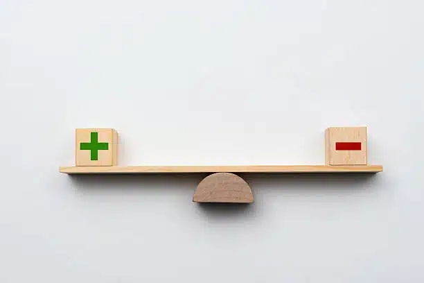 Seesaw with plus and minus blocks illustrating the balance in cargo calculation
