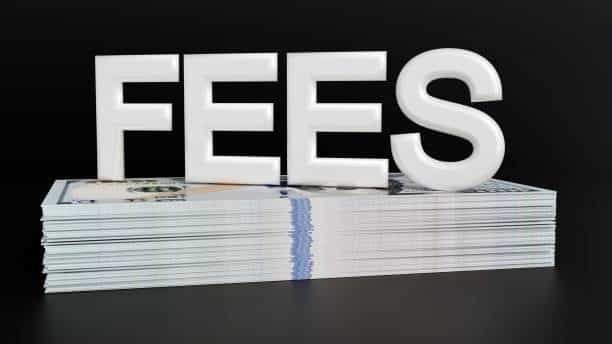 White 3D word "FEES" on stacked hundred-dollar bills representing freight costs
