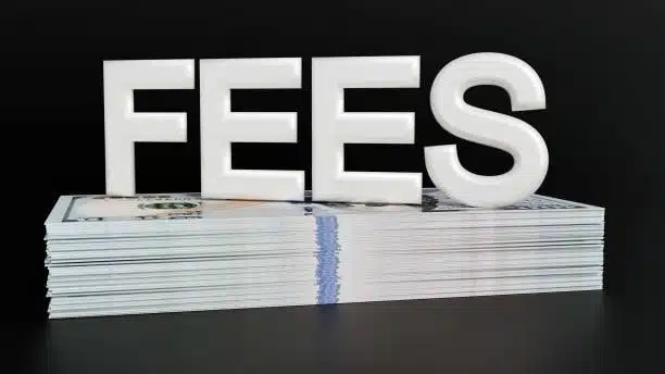 White 3D word "FEES" on stacked hundred-dollar bills representing freight costs