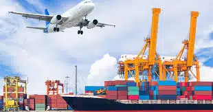 Airplane flying above port cranes and container ship, representing multimodal freight from China to Hong Kong.