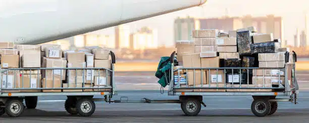 Carts filled with packages ready for air export from China to Kenya