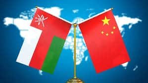 China and Oman flags symbolizing international trade partnership and shipping routes