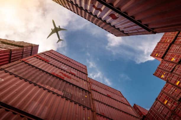 Cargo containers with an airplane above symbolizing air freight logistics from China to Colombia