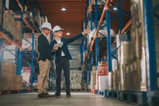 Logistics experts planning shipping operations from China to Somalia in warehouse