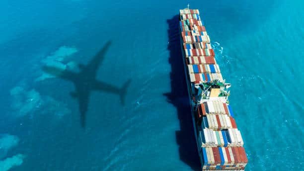 Aerial view of container ship at sea with airplane shadow – China to Sweden multimodal shipping