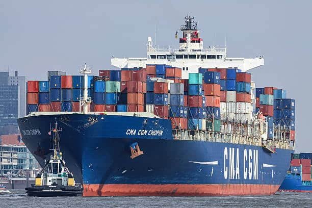 Front view of CMA CGM container ship with stacked cargo units for shipping