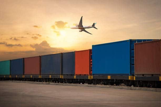 Colorful freight containers on train with airplane flying to the UK, representing cargo transit from China