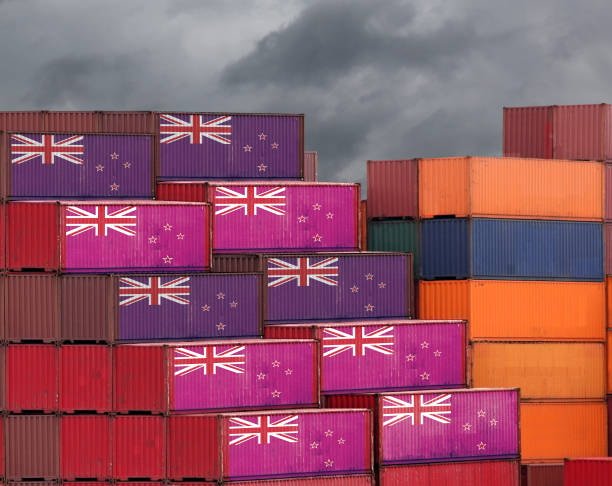Colorful stacked containers each marked with the New Zealand flag for export