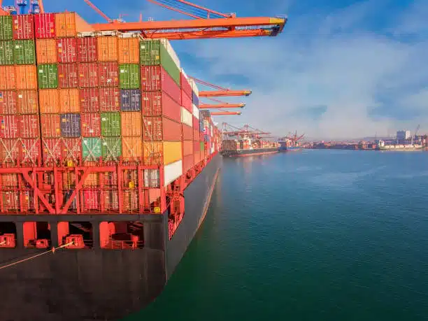 Loading containers onto a ship at a US port for export to Singapore