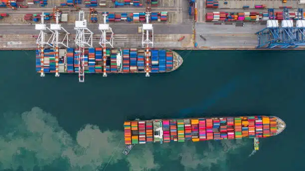 Sunset view over a Singapore container terminal busy with cranes and export containers