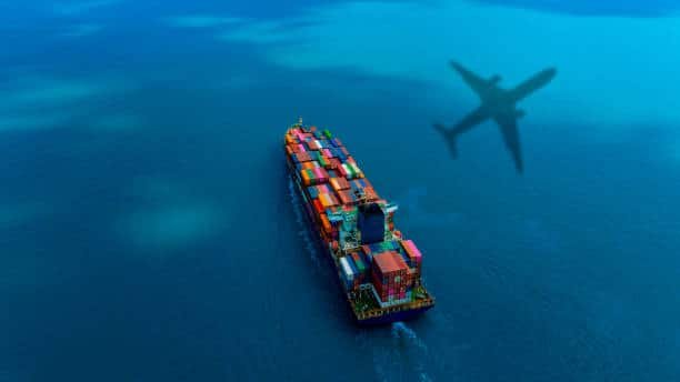 Aerial view of cargo vessel with airplane shadow, representing China to Belgium logistics route.