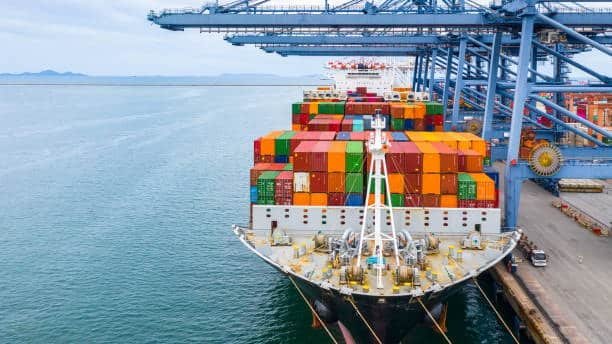Large container ship docked at port for ocean freight loading and unloading operations