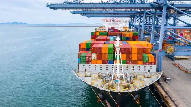 Large container ship docked at port for ocean freight loading and unloading operations