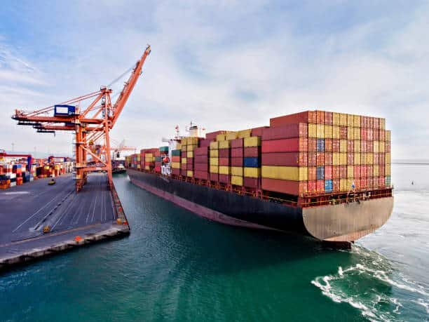 Large container ship arriving at port for international freight