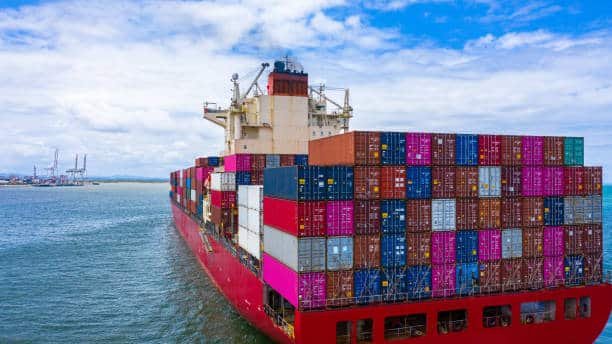 Large cargo ship transporting containers for ocean freight to Italy