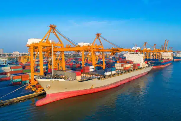 Top-down view of cargo vessel sailing with loaded containers