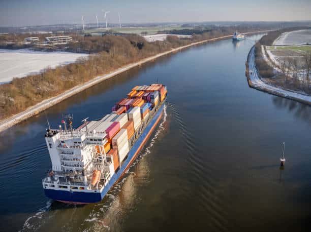 Container ship navigating a wide channel, symbolizing export journey from China to Africa