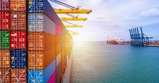 Side view of container vessel at port with cranes loading cargo for shipping to Jordan.