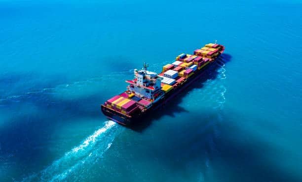 Container vessel in motion across clear blue sea