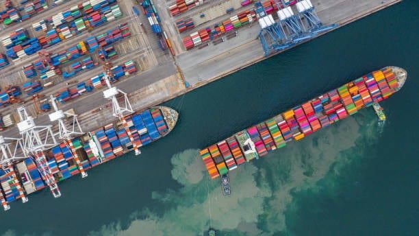 Multiple cargo ships approaching a Singaporean terminal, indicating high shipping volume