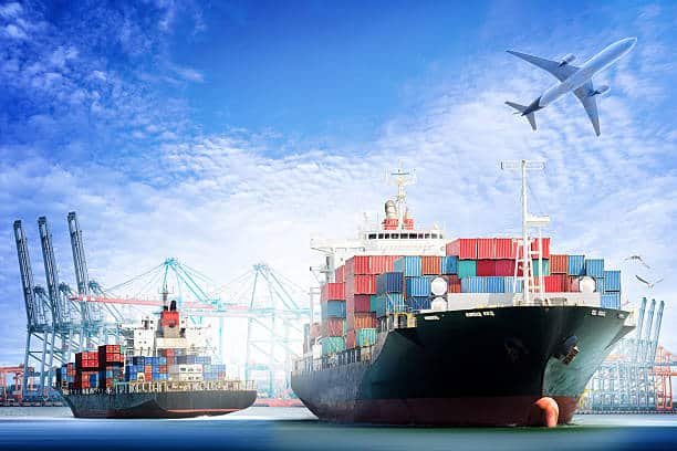 Cargo vessels at port with airplane overhead, highlighting China–Pakistan shipping routes