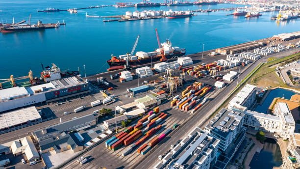 Aerial view of a busy container terminal with ships, trucks, and port cranes facilitating ocean logistics operations