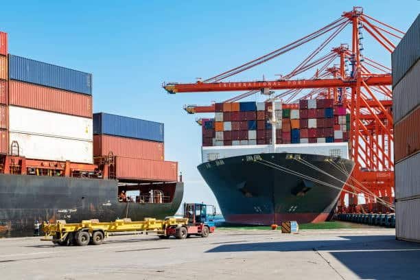 Large container ship at international port during FOB loading