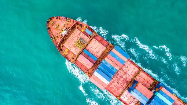 Aerial view of a container vessel transporting cargo overseas from the US to Singapore