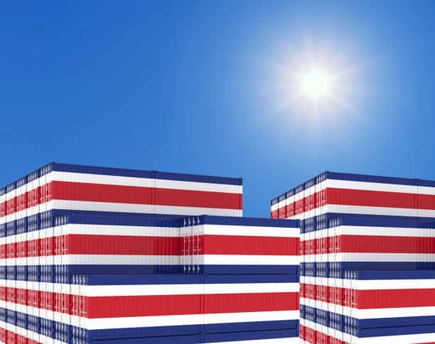 Stack of shipping containers painted in Costa Rica national colors under bright sky