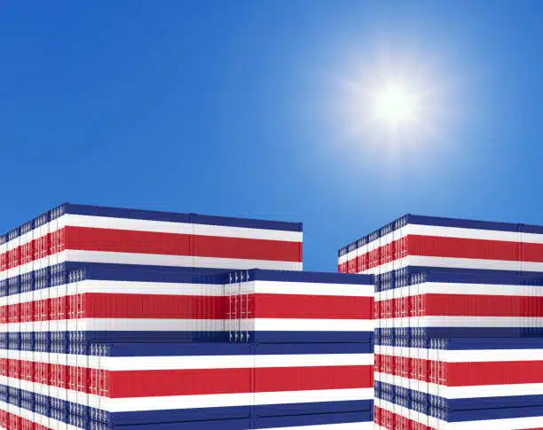 Stack of shipping containers painted in Costa Rica national colors under bright sky