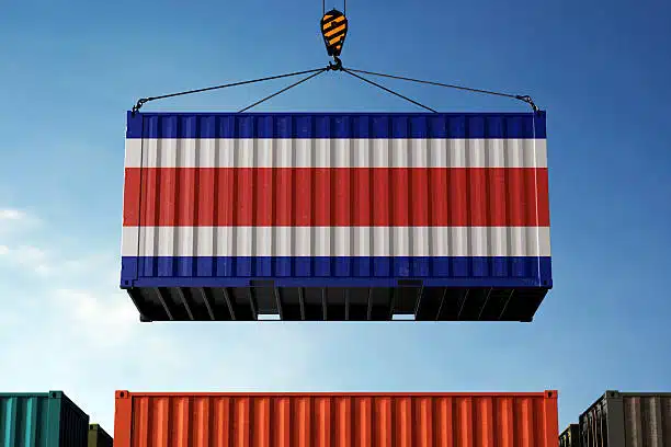 Cargo container painted with Costa Rica flag lifted by crane at shipping port