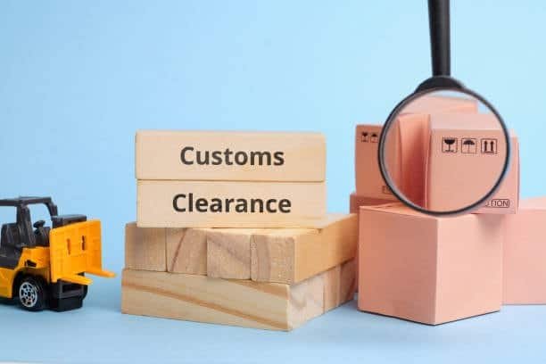 Wooden blocks with customs clearance text and packages under magnifier