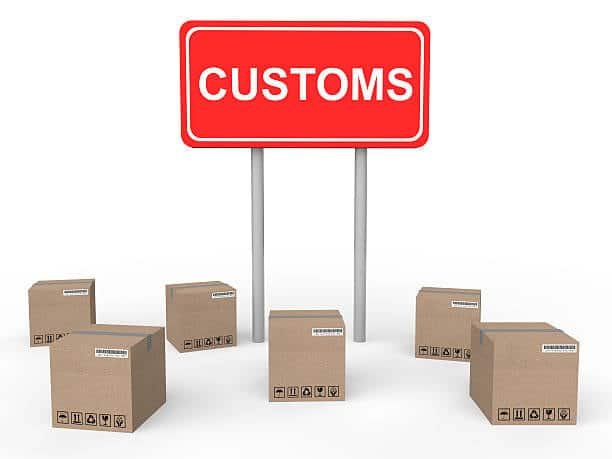 Green customs sign with shipping packages around