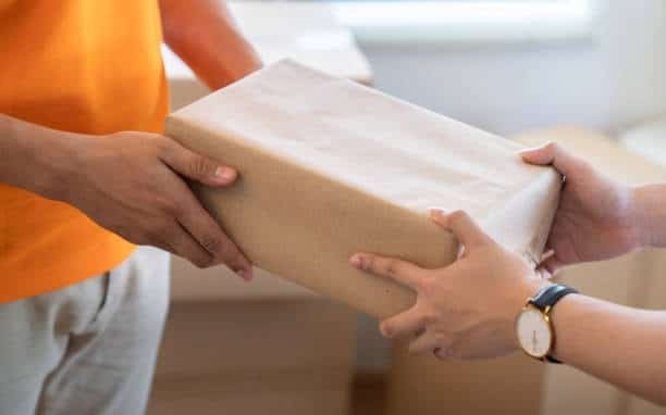 Hand-to-hand exchange of goods showcasing Delivered Duty Paid logistics