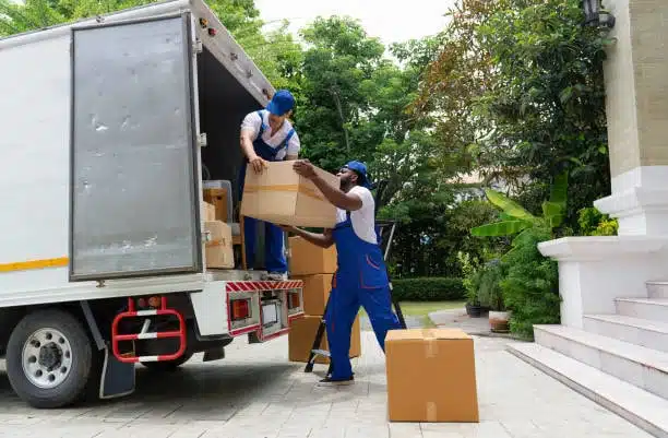 Workers unloading packages from truck as part of DDP delivery logistics