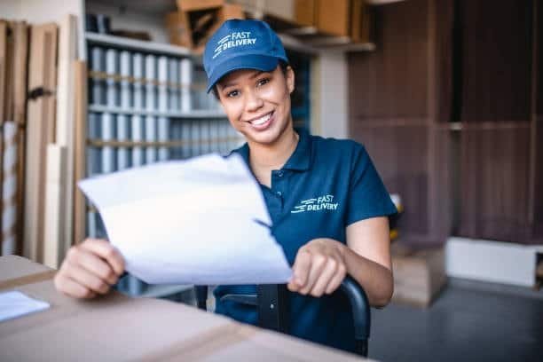 Courier showing a bill of lading or delivery form during logistics process