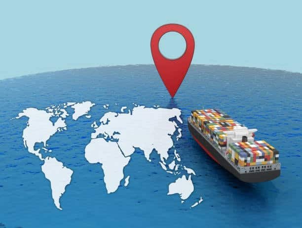 cargo ship heading toward destination port with location pin symbol