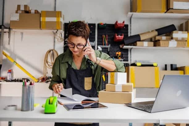 Small business owner managing online orders and packaging for dropshipping business