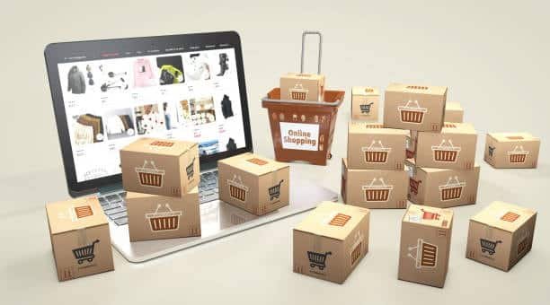 Laptop showing online store interface with small boxes representing eCommerce and dropshipping logistics