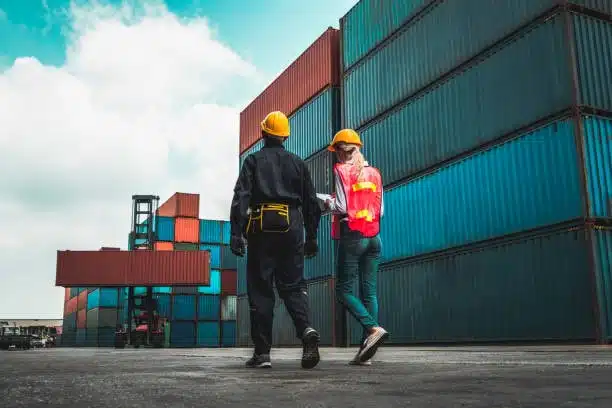 Logistics workers reviewing documentation for eBay order fulfillment, highlighting the importance of meeting shipping timeframes.