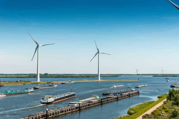 Eco-friendly shipping vessels and wind turbines representing sustainable freight