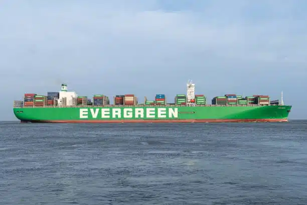 Evergreen shipping line vessel loaded with containers cruising in open waters