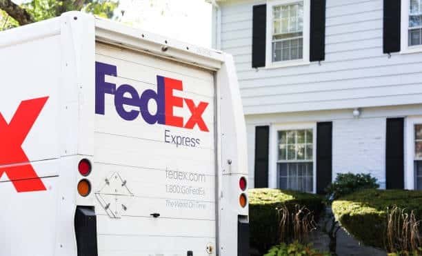 FedEx Express van parked outside a residential home representing home delivery service