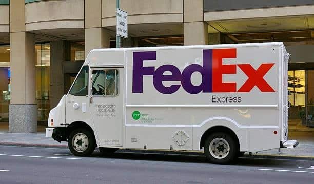 FedEx delivery truck on a city street, suitable for SmartPost or Express shipping routes