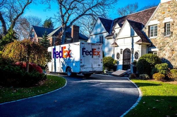 FedEx truck on a driveway during a suburban delivery route for residential packages
