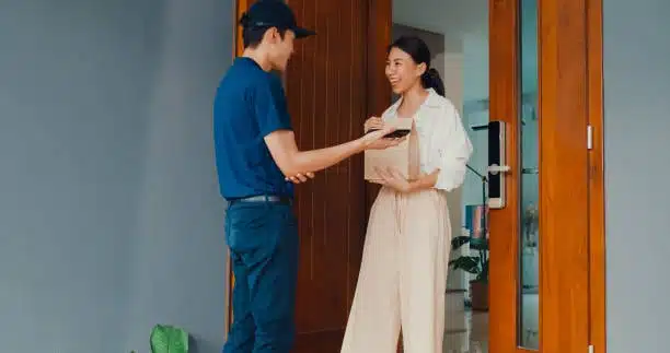 Courier completing final doorstep delivery in door-to-door transport process