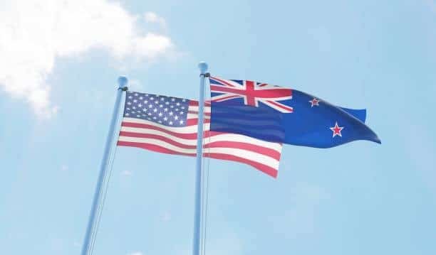Flags of the United States and New Zealand waving side by side