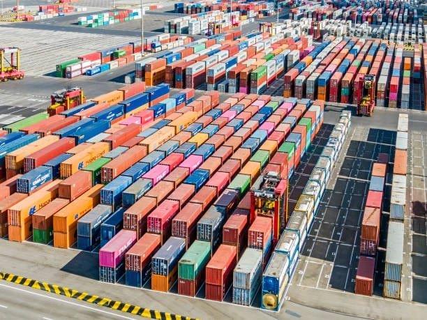 Rows of freight containers organized at a shipping yard before departure