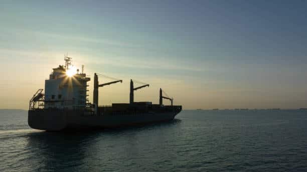 Ocean freight ship transporting containers, symbolic of long-haul shipping prior to local drayage delivery.